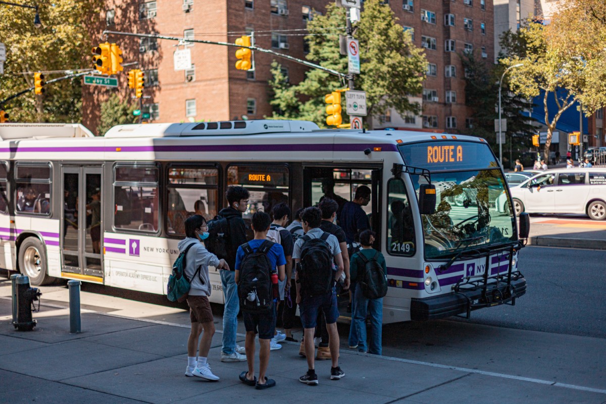 Students line up on Jay Street in Brooklyn Metrotech to board a Route A shuttle to N.Y.U.’s Washington Square campus.